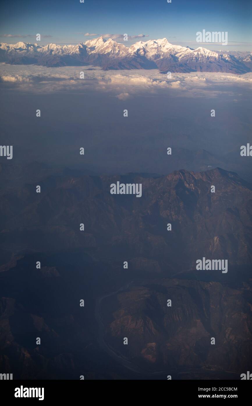 Himalaya Mountains of Nepal as seen from a passenger plane window. Stock Photo