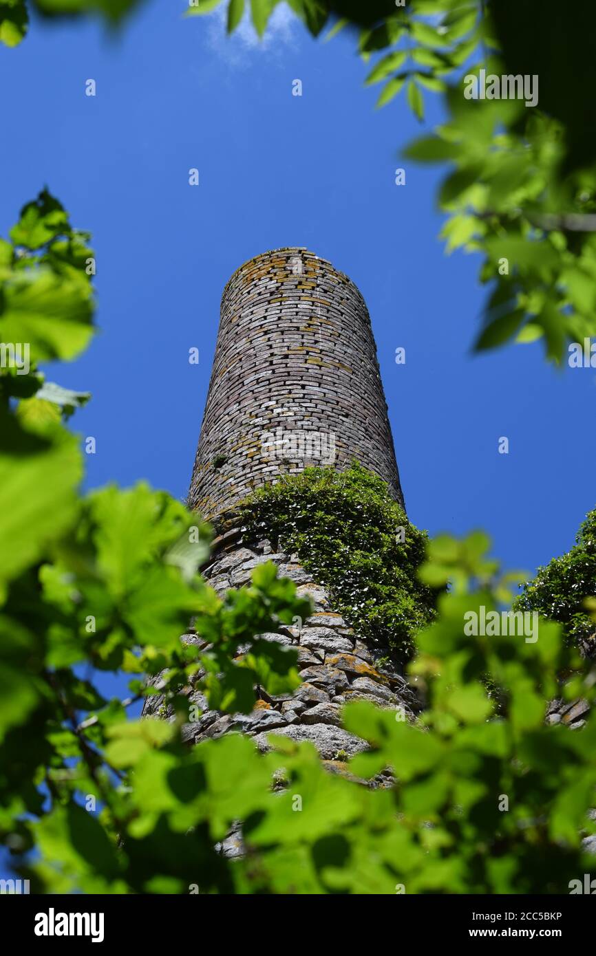 Tin mine chimney against blue sky Stock Photo