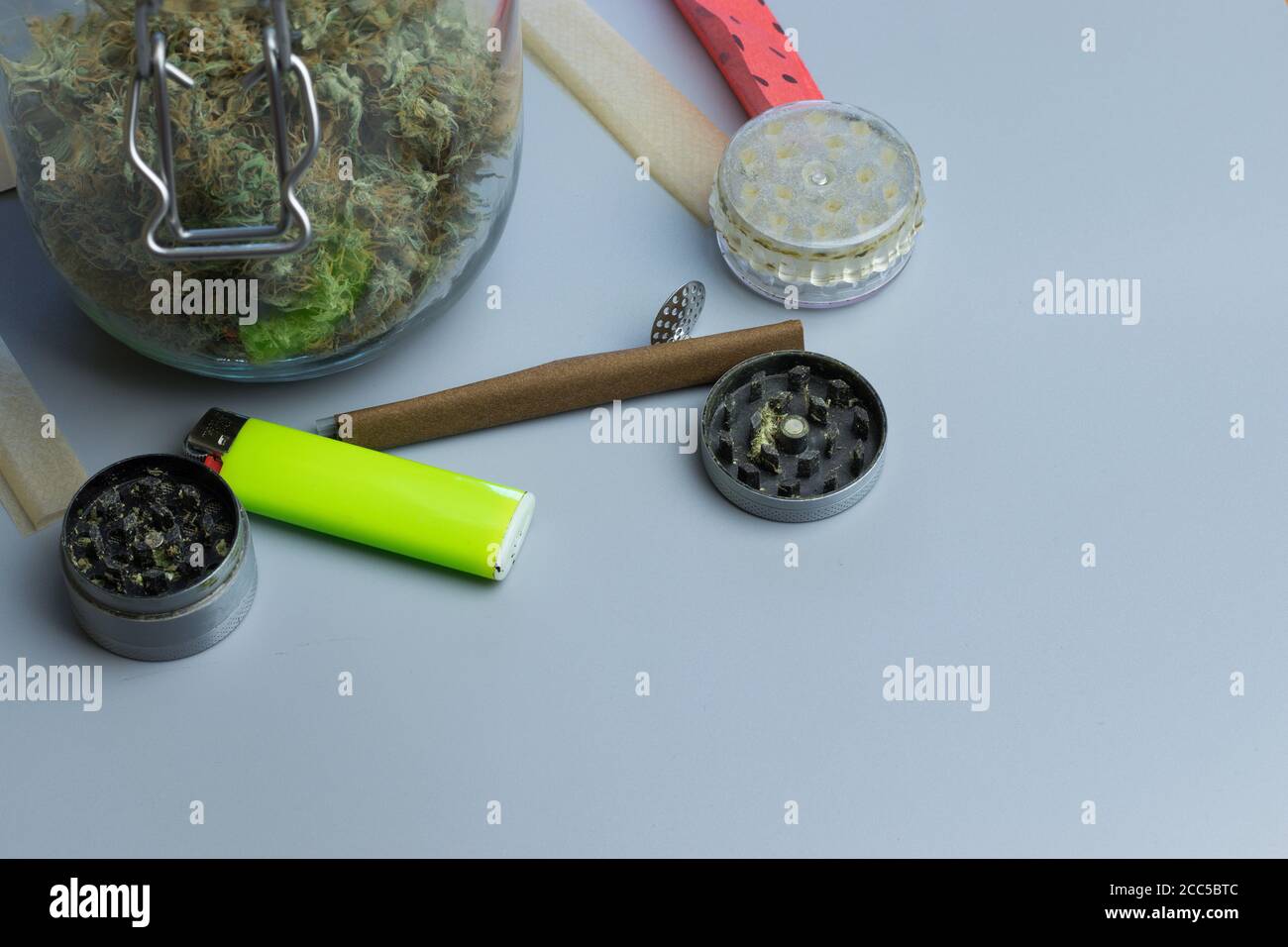 Grinder, lighter and smoking paper for cannabis medical use. Healthcare and  THC. Marijuana treatment of anxiety. Copy space near weed jar Stock Photo -  Alamy