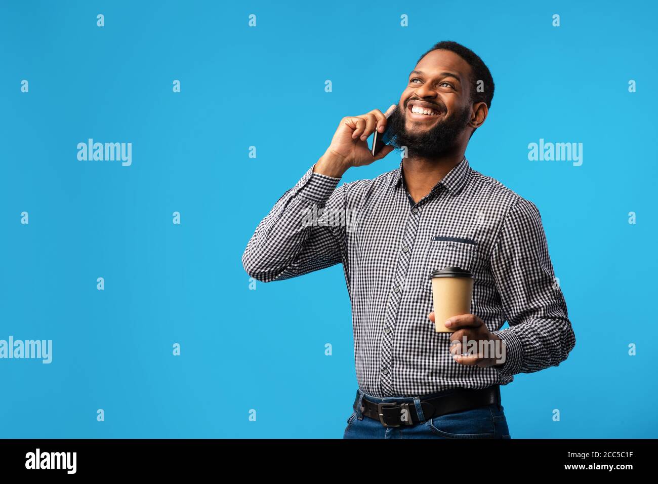 Smiling black man talking on the phone at studio Stock Photo