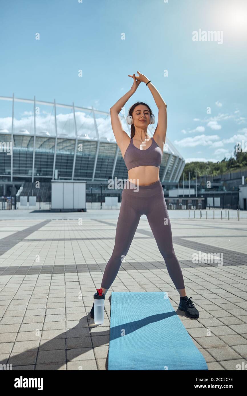 Fit female stretching with her eyes closed Stock Photo
