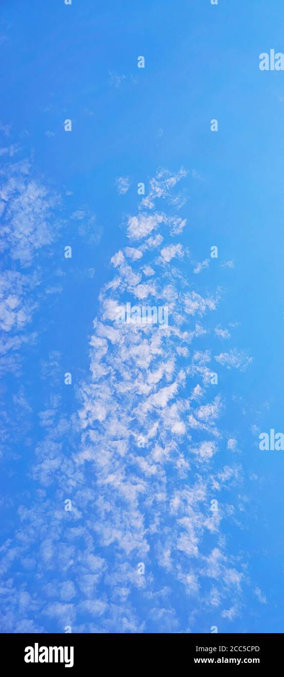 Vertical panorama of a blue sky with beautiful white clouds Stock Photo ...