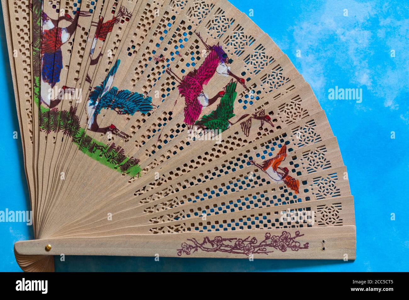 decorative hand held wooden bamboo fan from Myanmar (Burma) set against