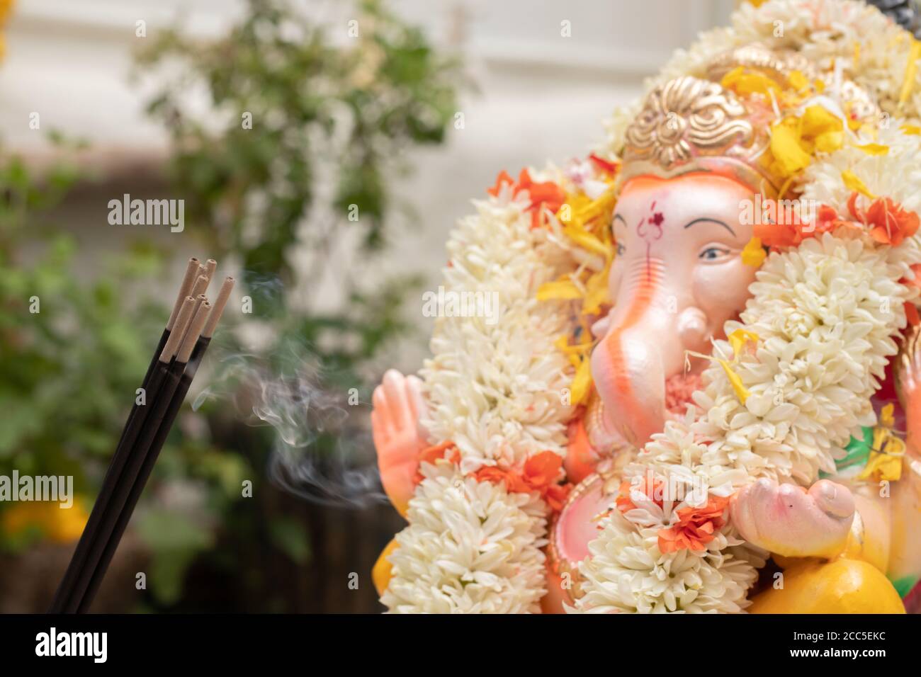 Incense or agarbatti sticks in front of lord vinayaka or Ganesha ...