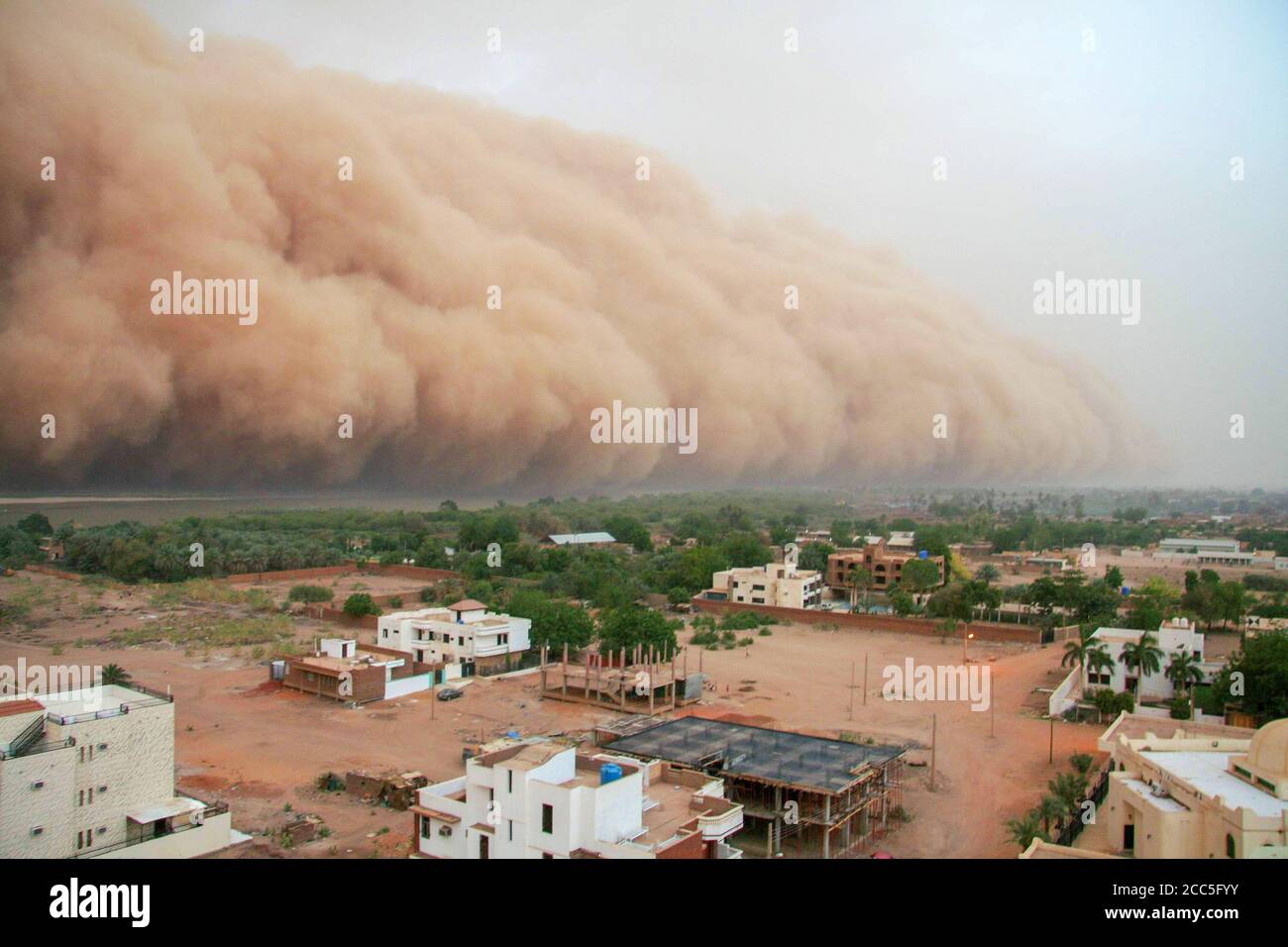A haboob approaching the outskirts of Khartoum, Sudan. A haboob is a type of intense dust storm carried on wind that occur regularly in Sudan. Stock Photo