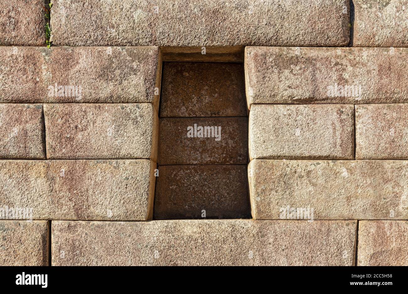 Trapezoid cavity in an Inca wall with perfect stonework, Machu Picchu, Cusco, Peru. Stock Photo
