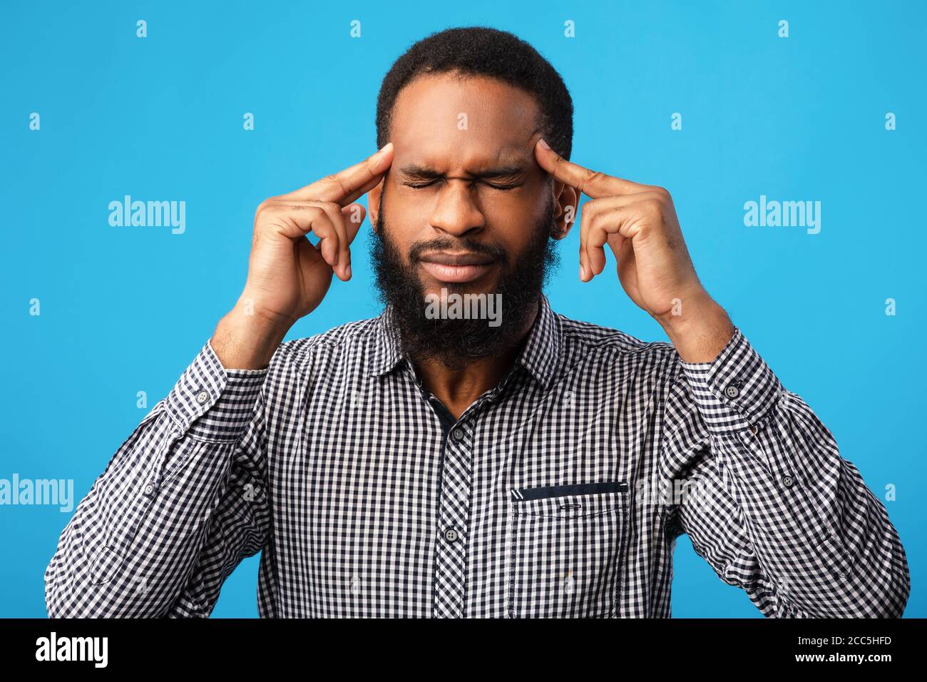 Pensive afro man portrait on blue background Stock Photo