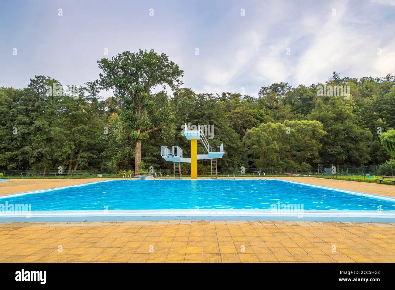 vacant outdoor swimming pool with diving tower Stock Photo