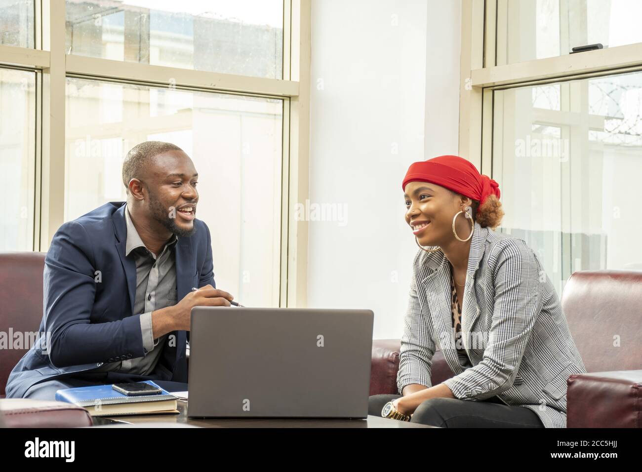 Young black businessman and woman discussing business Stock Photo