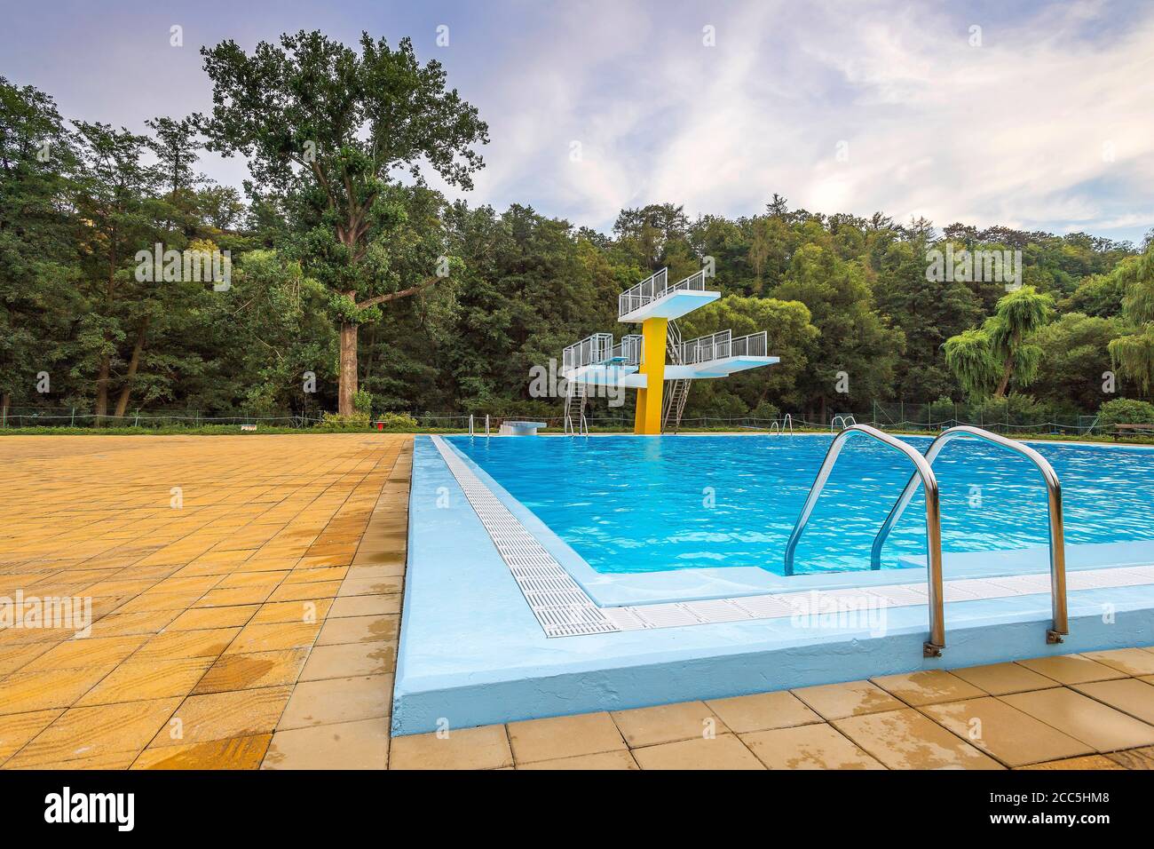 vacant outdoor swimming pool with diving tower Stock Photo