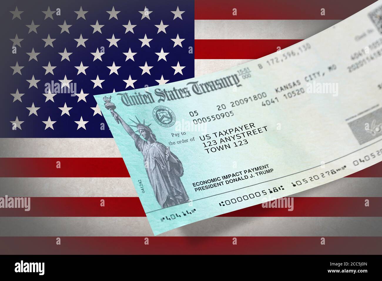 United States Federal Government Coronavirus stimulus check, or 'Economic Impact Payment over flag of United states. Stock Photo