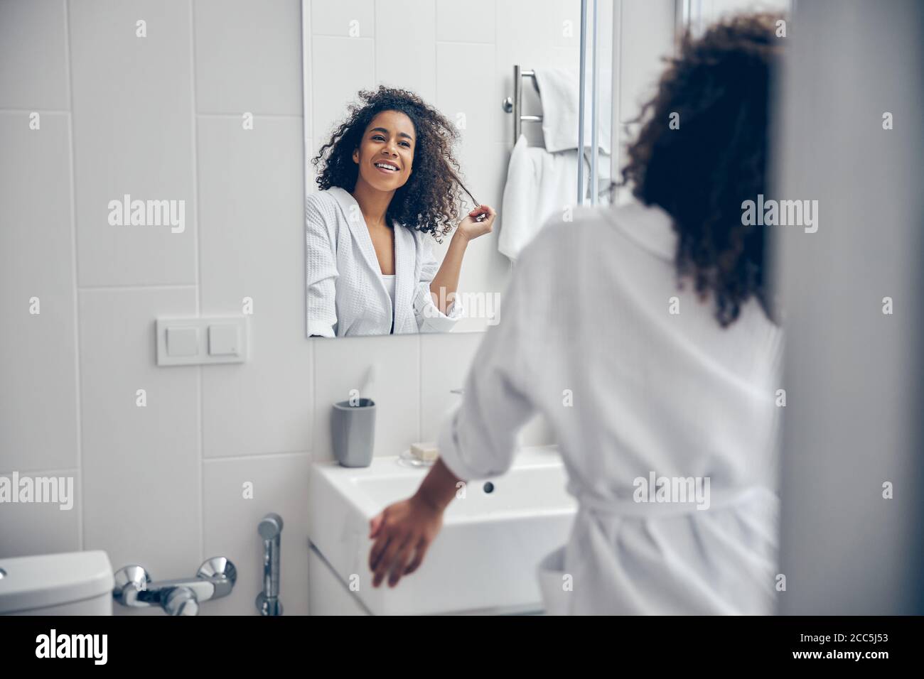 Contented cute lady standing in the bathroom Stock Photo - Alamy