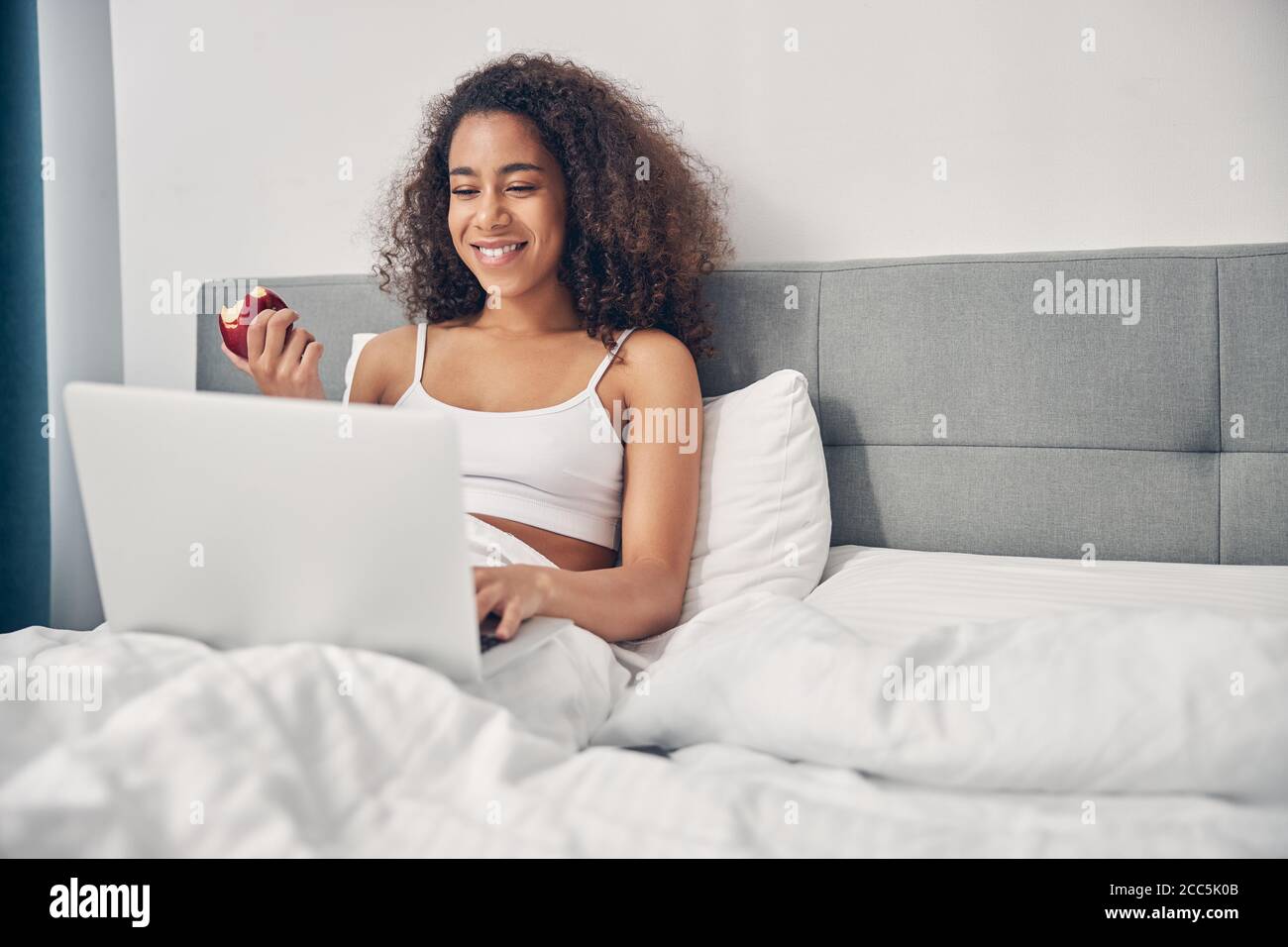 Pleased woman using computer hi-res stock photography and images - Alamy