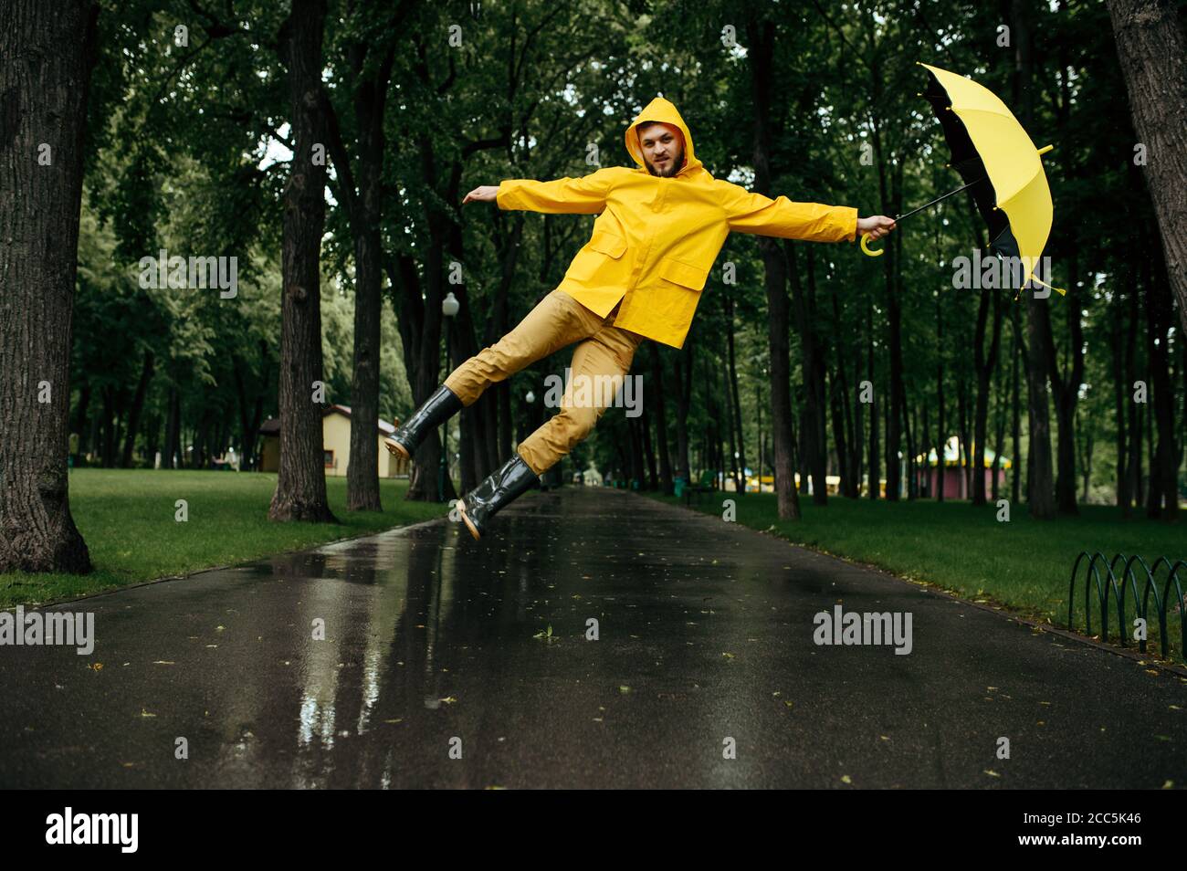 Man flying with umbrella in windy rainy day Stock Photo