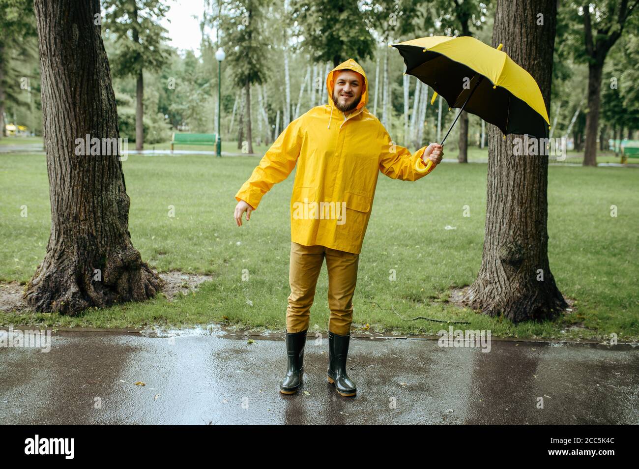 Man with umbrella walking in windy rainy day Stock Photo
