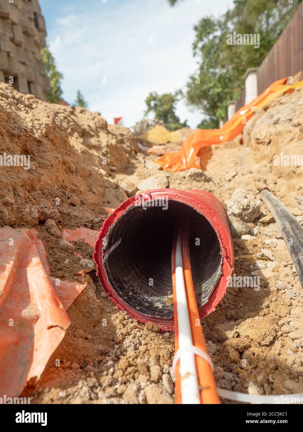 Data fiber optic cables in ribbed pipe under road. Wire in HDPE and protectivep tube. Building