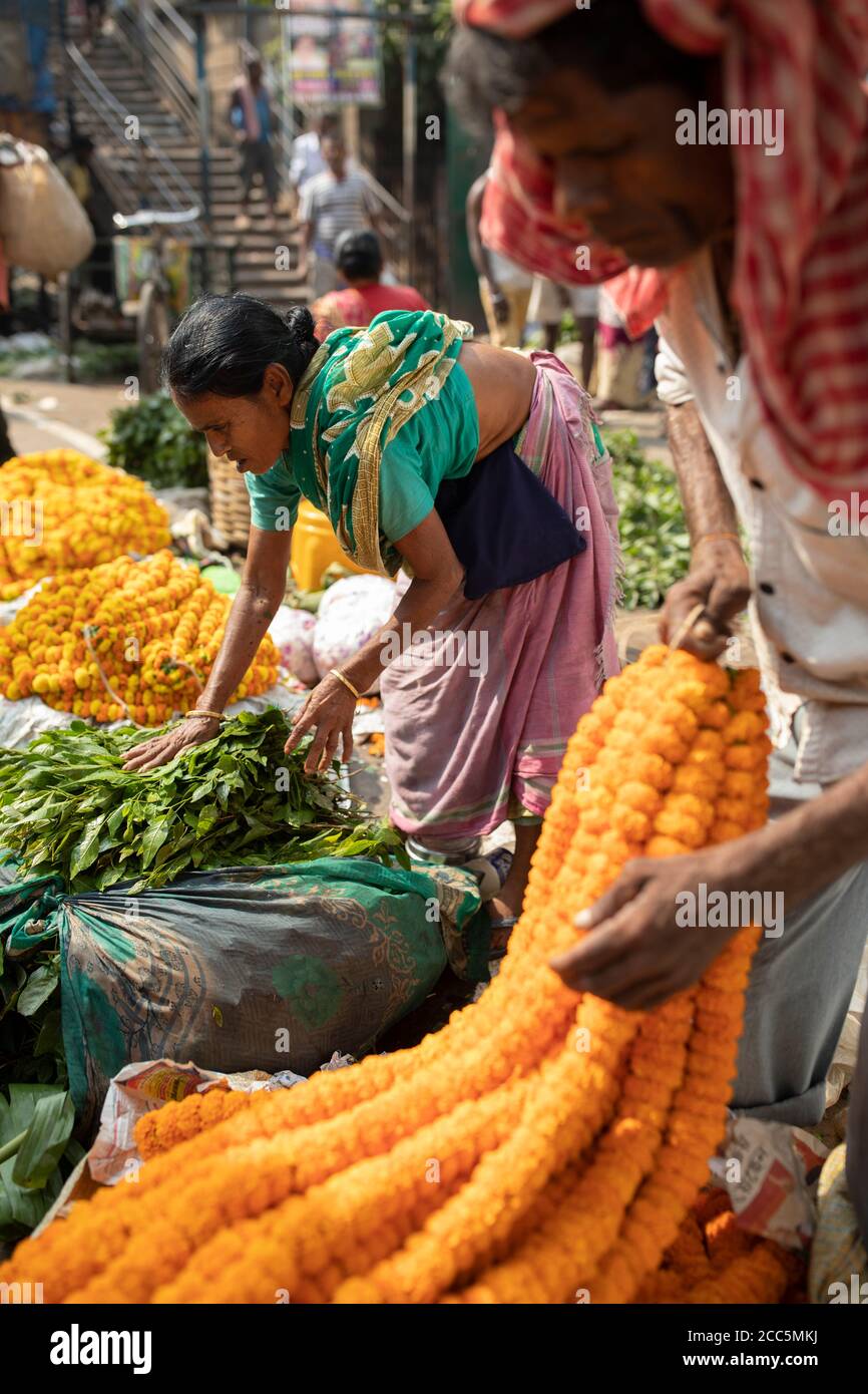 Vendors buy and sell beautiful garlands of marigold and lotus flowers