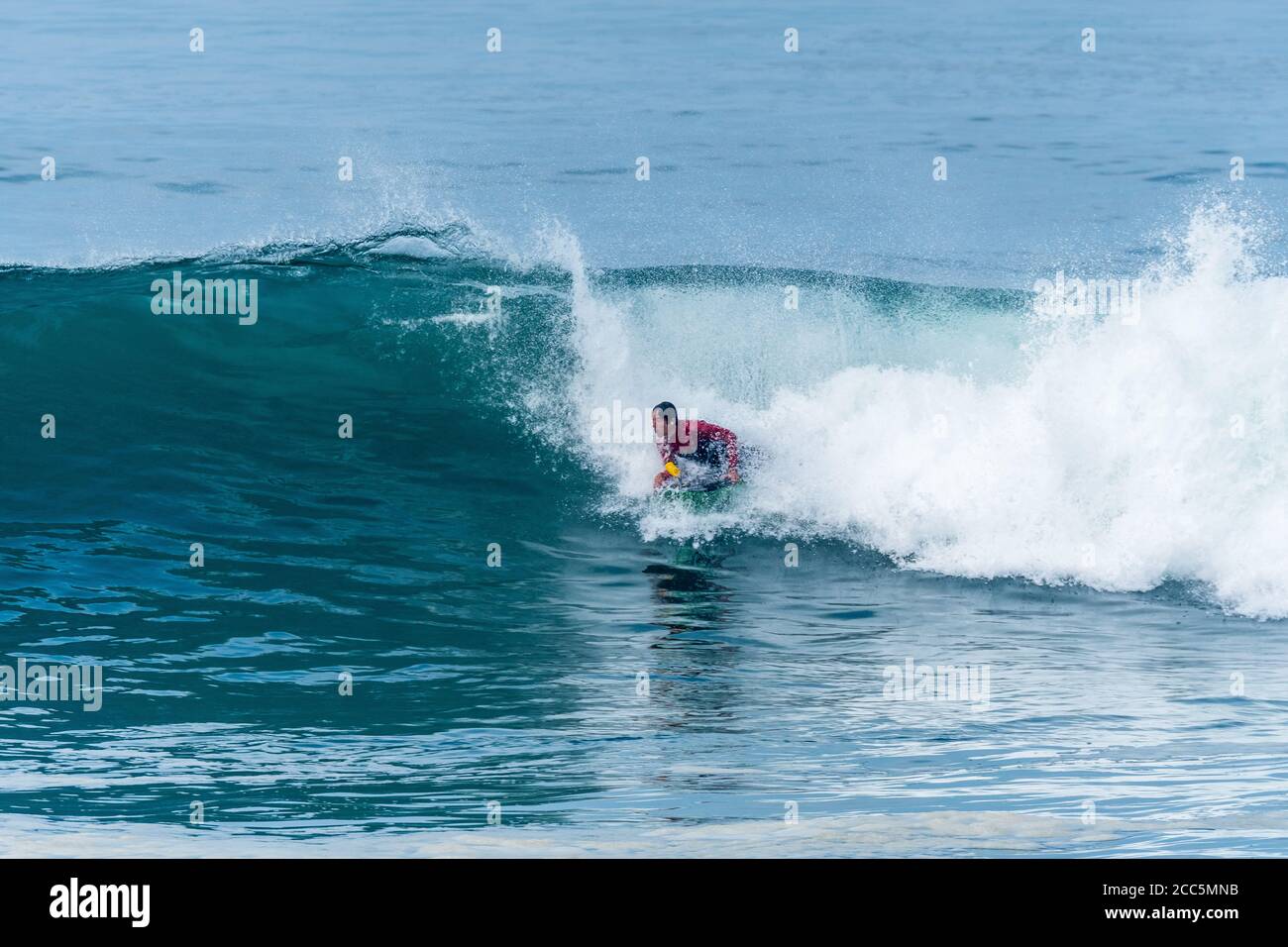 Bodyboarder surfing ocean wave on a sunny day Stock Photo - Alamy