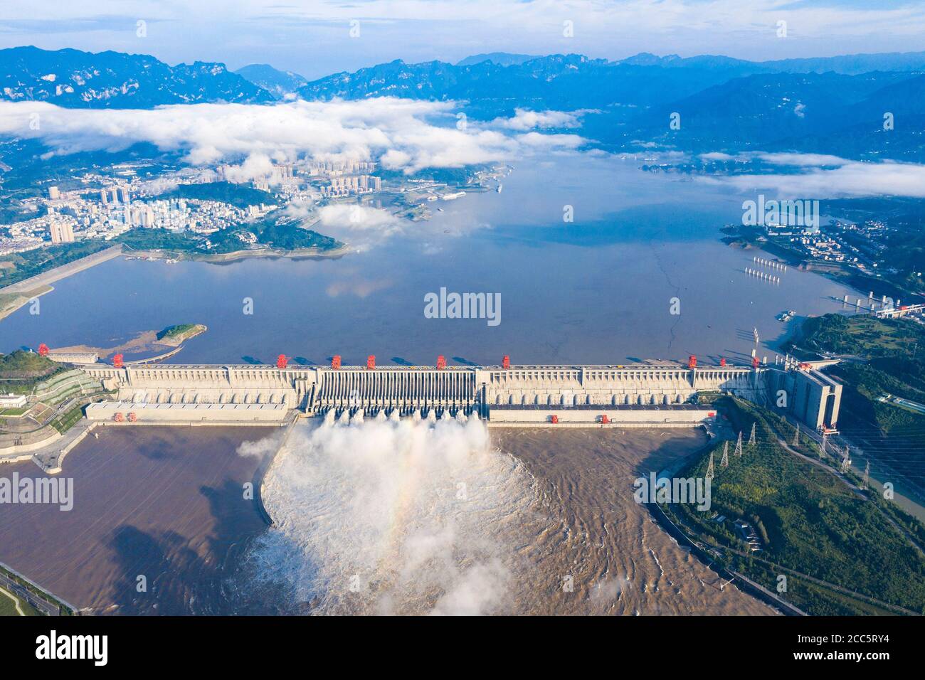 Yangtze River, Hubei, China. 19th Aug 2020. Aerial photo taken on Aug. 19, 2020 shows water gushing out from the Three Gorges Dam in central China's Hubei Province. China's Ministry of Water Resources (MWR) on Wednesday raised the emergency response for flood control to level II, the second-highest in the response system, as heavy rainfall lashed stretches along the Yangtze River. The upper reaches of the Yangtze River have been battered by the largest floods since 1981, according to the ministry. Credit: Xinhua/Alamy Live News Stock Photo