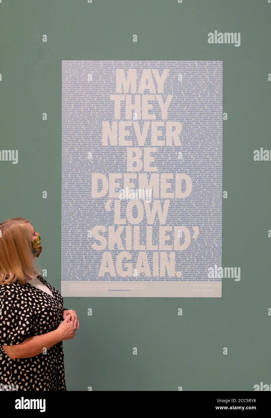 Manchester, UK. 19th Aug, 2020. Curator Fiona Corridan with Craig Oldham's 'Key Workers Poster' (2020) as Manchester Art Gallery prepares to reopen its doors to the public on Thursday 20th August following temporary closure during the Covid-19 outbreak Credit: Russell Hart/Alamy Live News Stock Photo