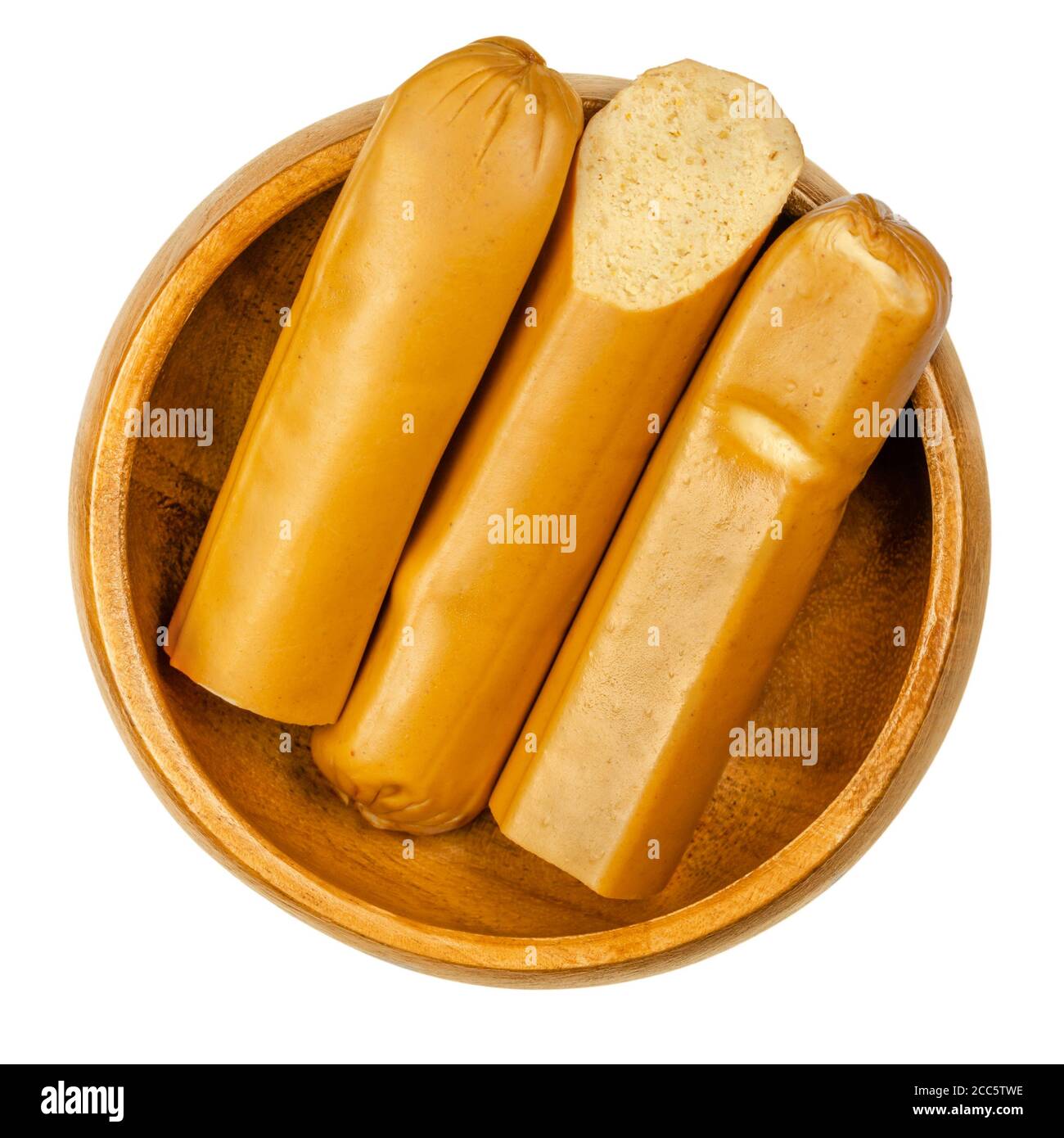 Vegan Vienna sausages in wooden bowl. Thin parboiled sausages, made of tofu then given a low temperature smoking. Also called Wiener or Frankfurter. Stock Photo