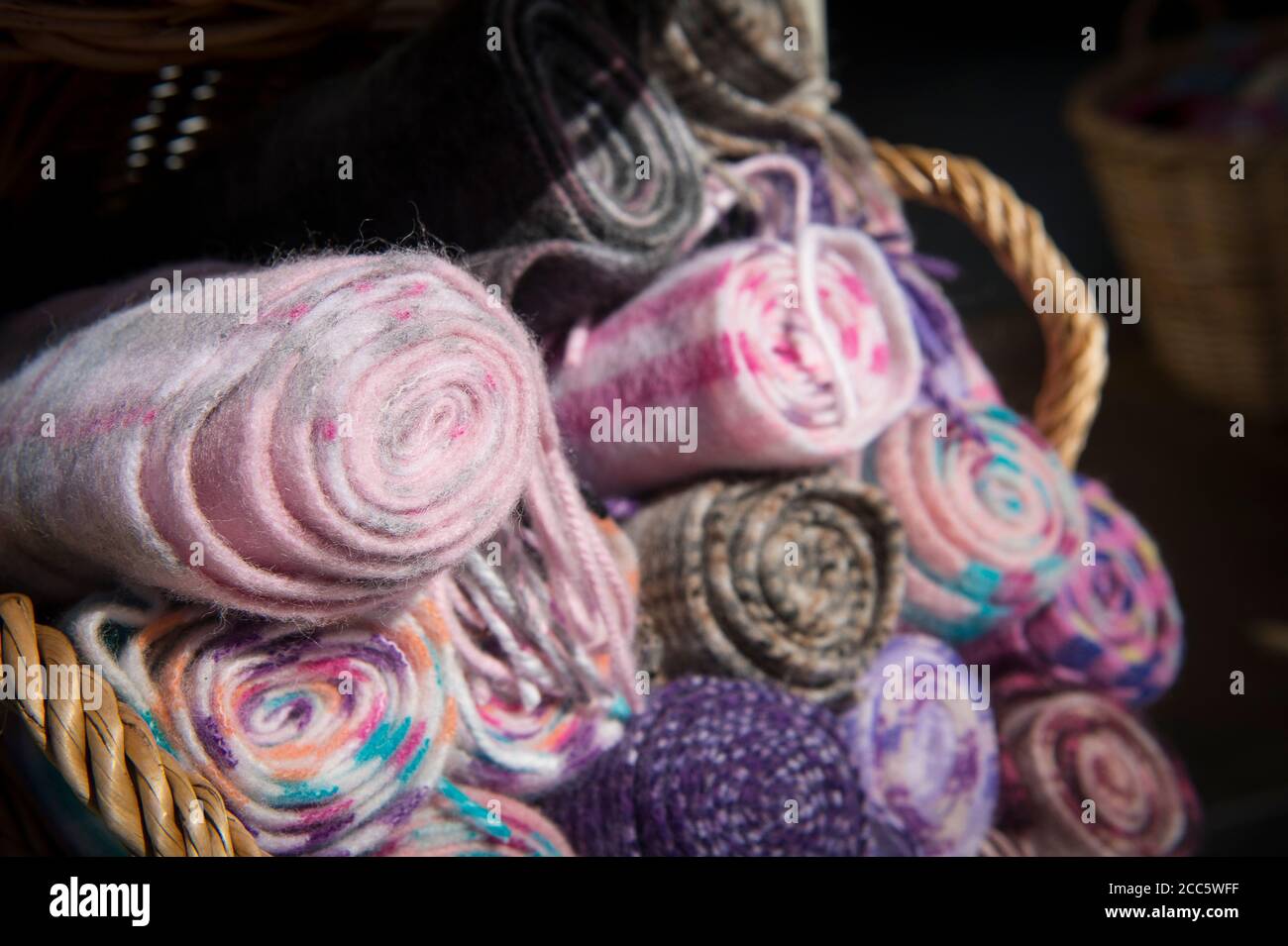 Basket of scarves for sale outside a shop. Stock Photo