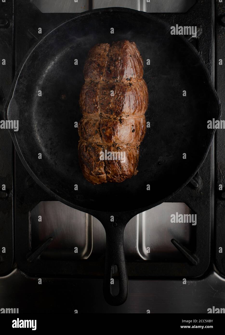 Fillet cooking in cast iron pan Stock Photo Alamy