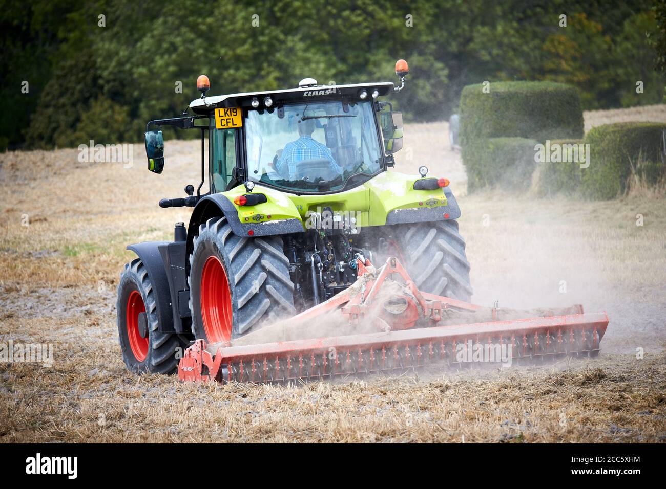 Claas tractor harvesting in UK Stock Photo