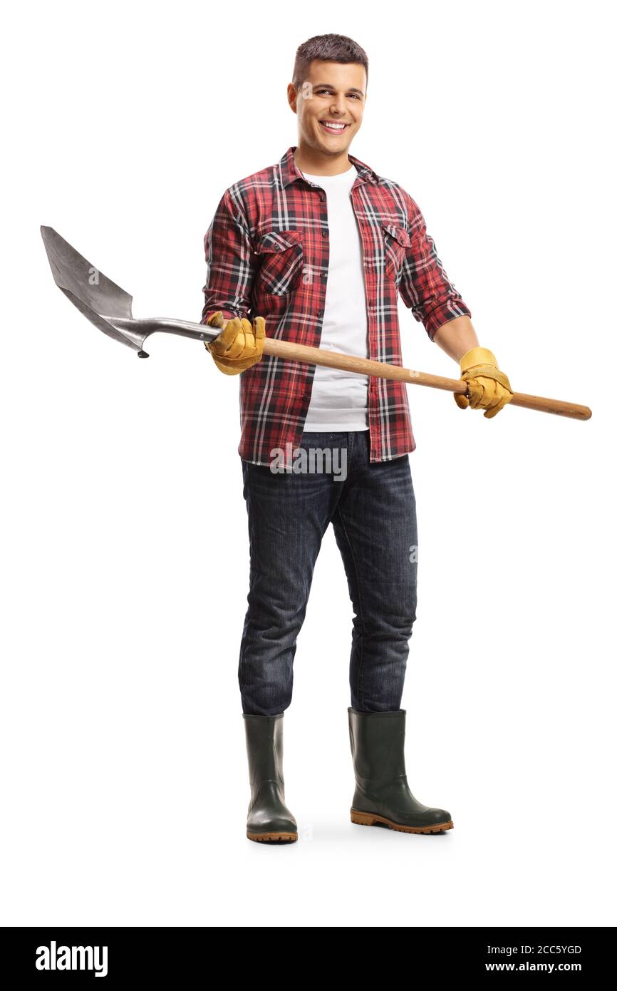 Full length portrait of a male gardener in boots holding a shovel ...