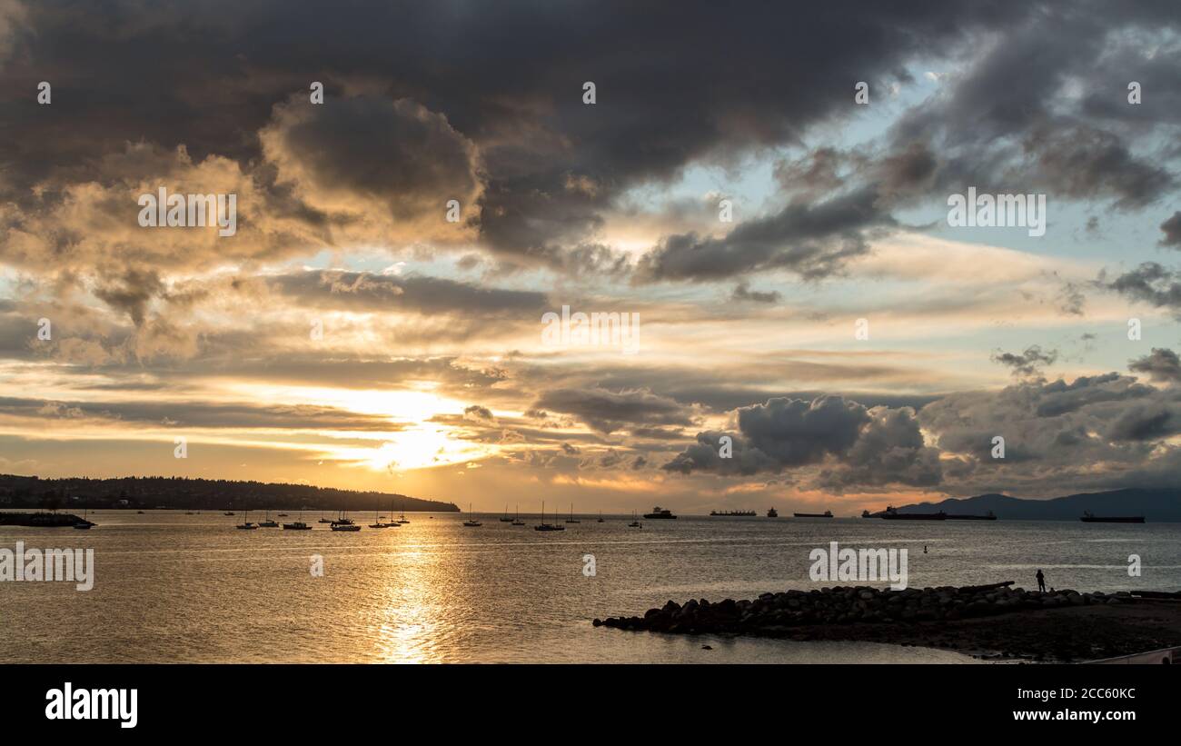 Golden sunset cloud sky ocean view at English Bay, Vancouver, BC, Canada Stock Photo