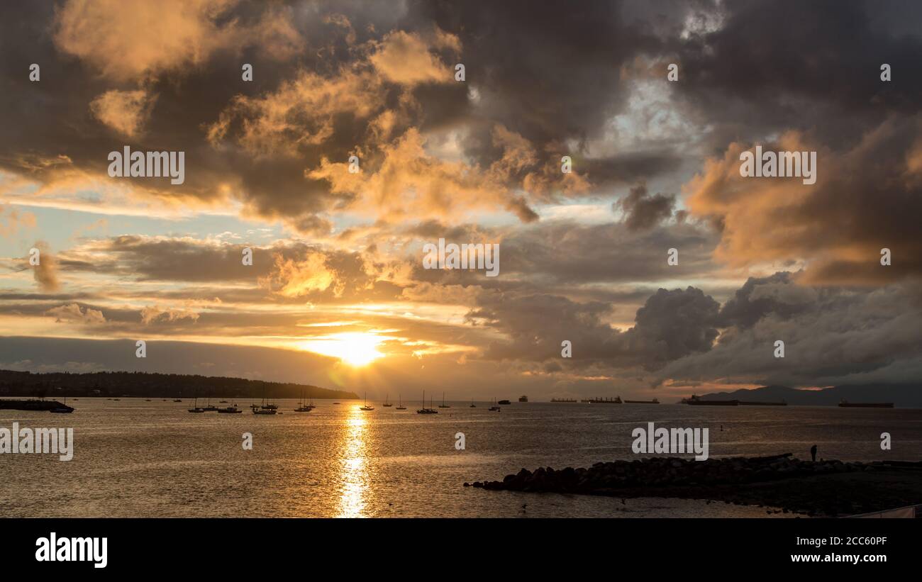 Golden sunset cloud sky ocean view at English Bay, Vancouver, BC, Canada Stock Photo