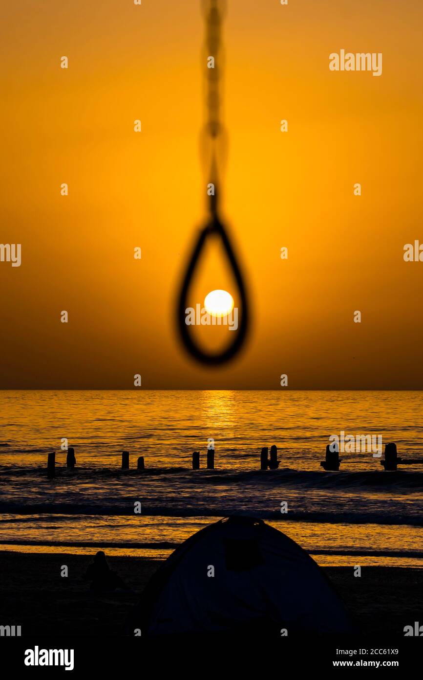 Setting sun as seen through a noose Photographed over the Mediterranean Sea, Israel Stock Photo