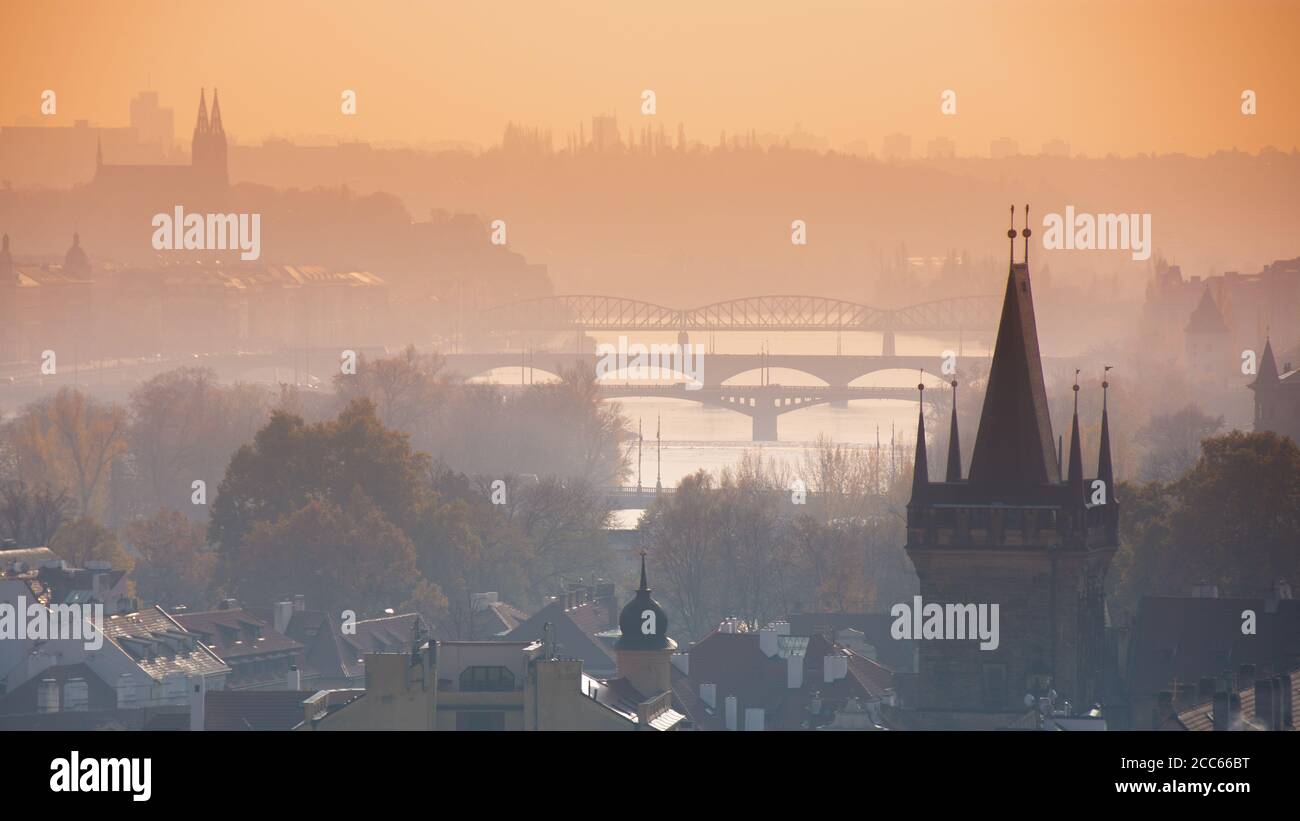 Panorama of Prague with the gothic tower of Charles bridge and the silhouettes of bridges over the river Vltava (Moldau), Czech Republic Stock Photo