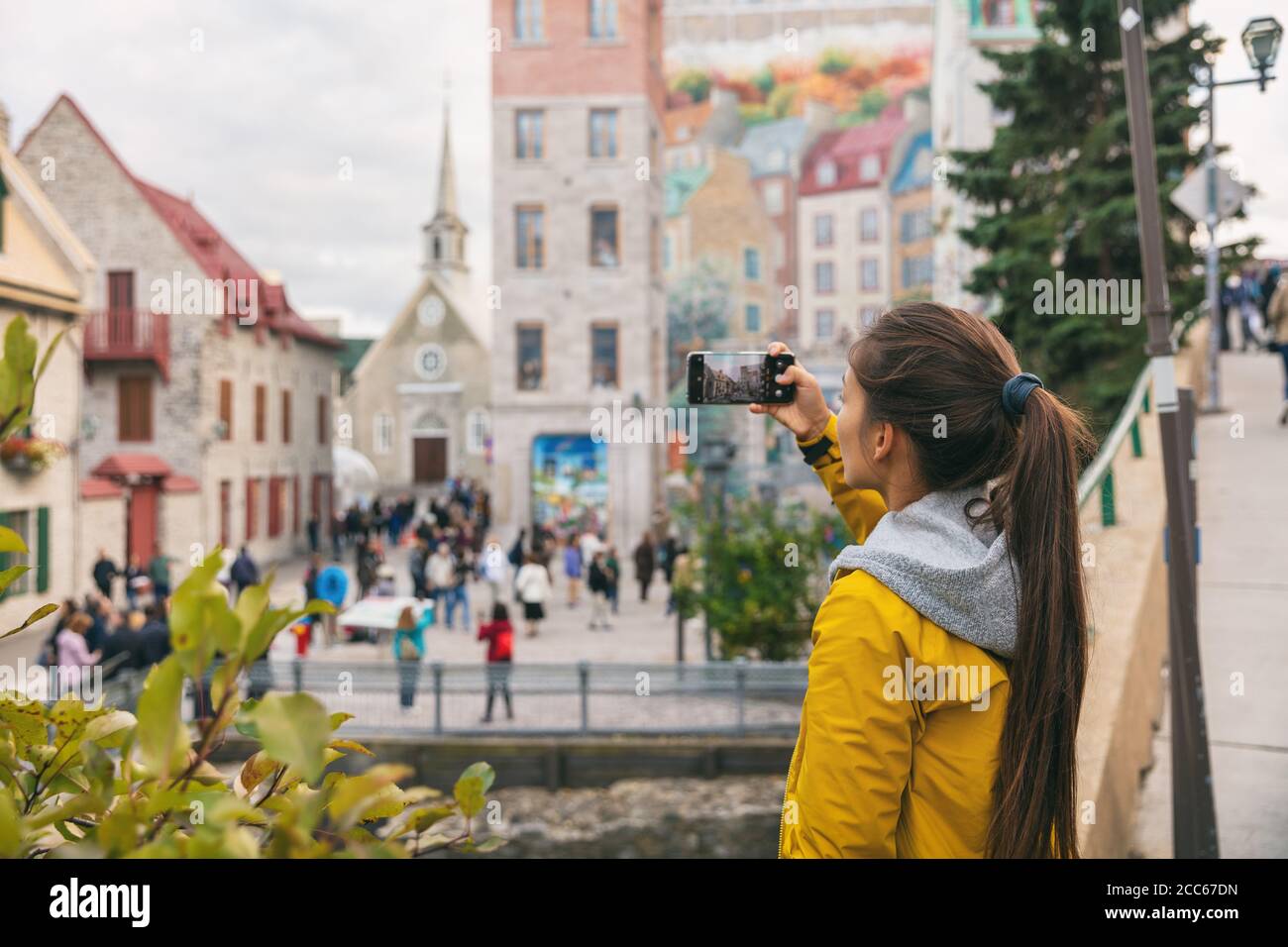 Quebec City Old Town Woman Tourist Taking Picture With Phone Of Famous Wall Art Mural In Place Royale Autumn Canada Travel Stock Photo Alamy