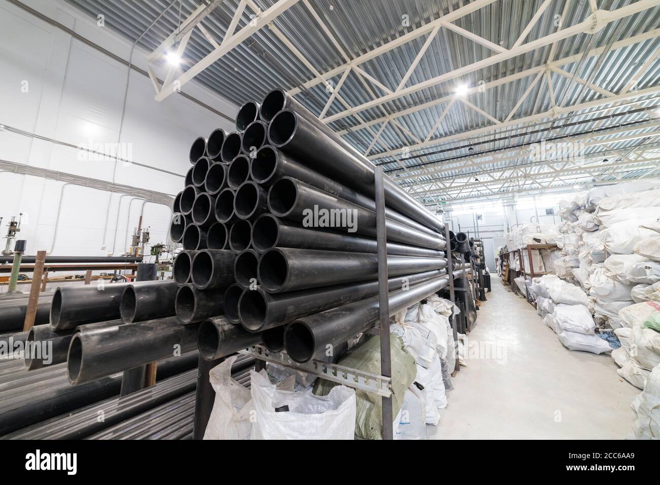 Black plastic tubes in the manufacturing centre. Mid shot Stock Photo