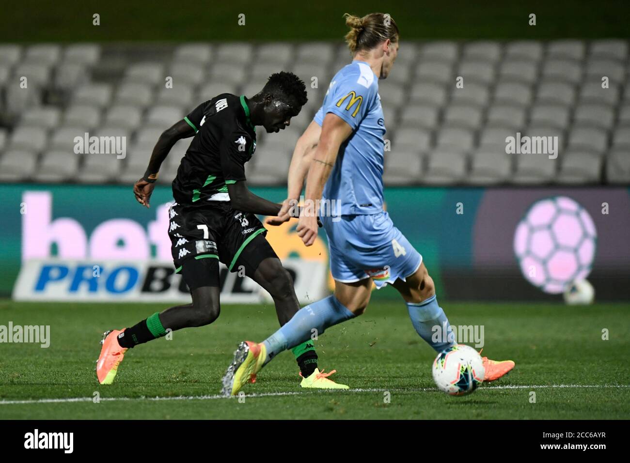 19th August 2020; Jubilee Oval, Sydney, New South Wales, Australia; A League Football, Western United FC versus Melbourne City FC; Kuach Yuel of Western Unite shoots as Harrison Delbridge of Melbourne City attempts to block the shot Stock Photo