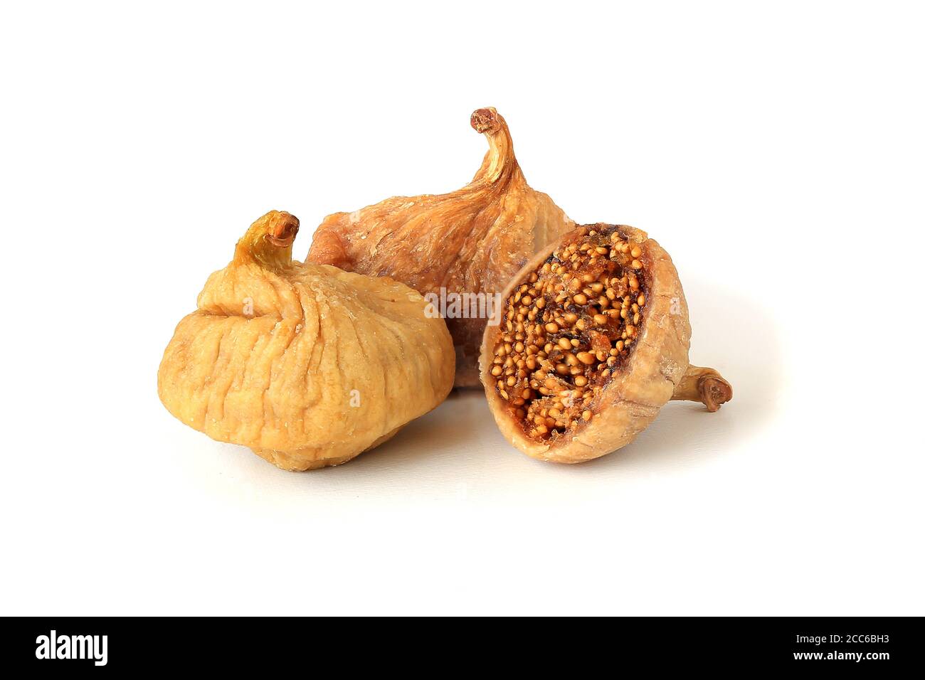 Two dried figs and helf isolated on white background Stock Photo