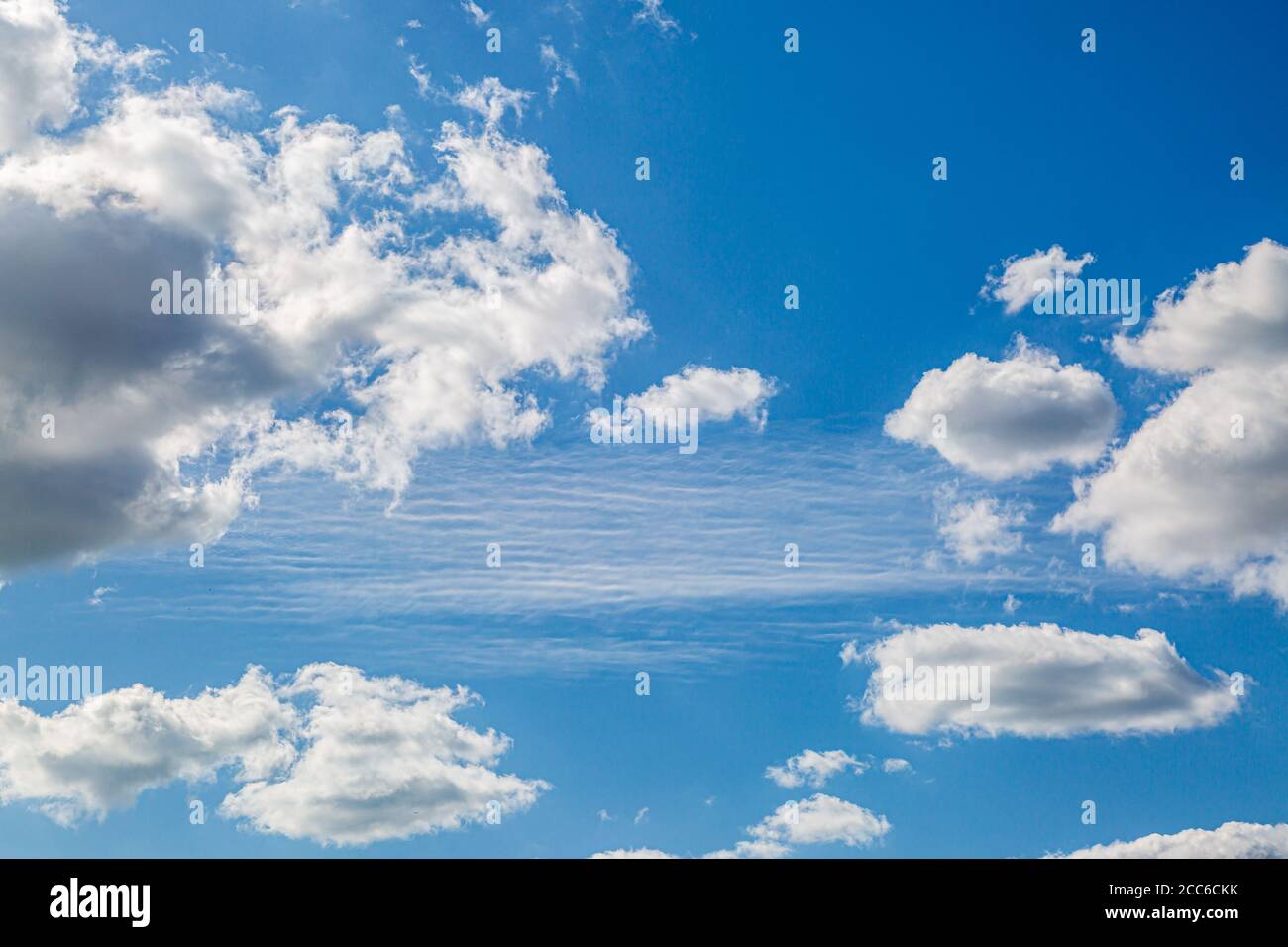 Looking up at blue sky and fluffy white clouds Stock Photo