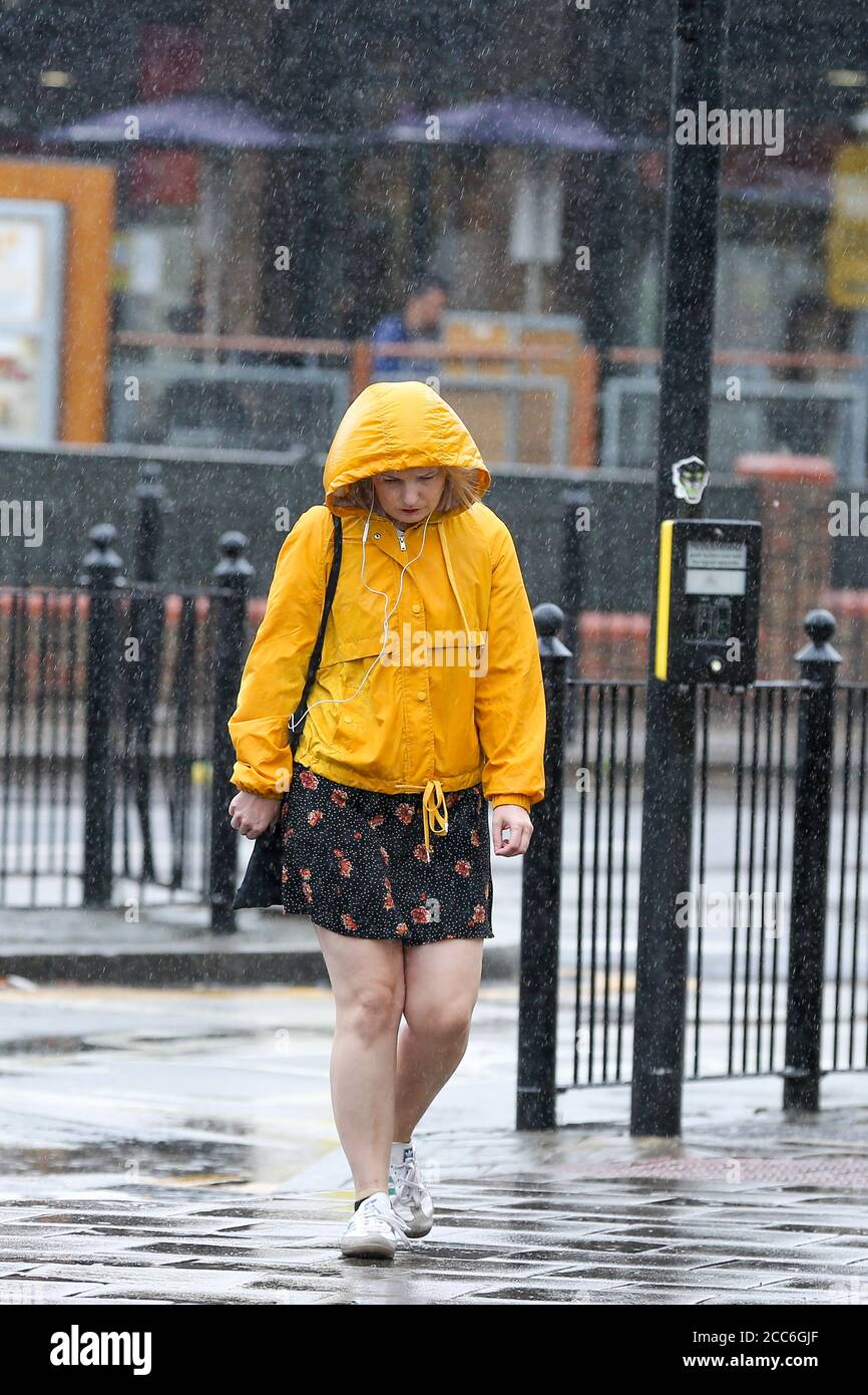 London, UK 19 Aug 2020 - A woman is caught out as Storm Ellen brings heavy rainfall with gusty winds in north London. According to the Met Office warmer weather with highs of 24 degrees celsius is forecasted for the rest of the week. Credit: Dinendra Haria/Alamy Live News Stock Photo