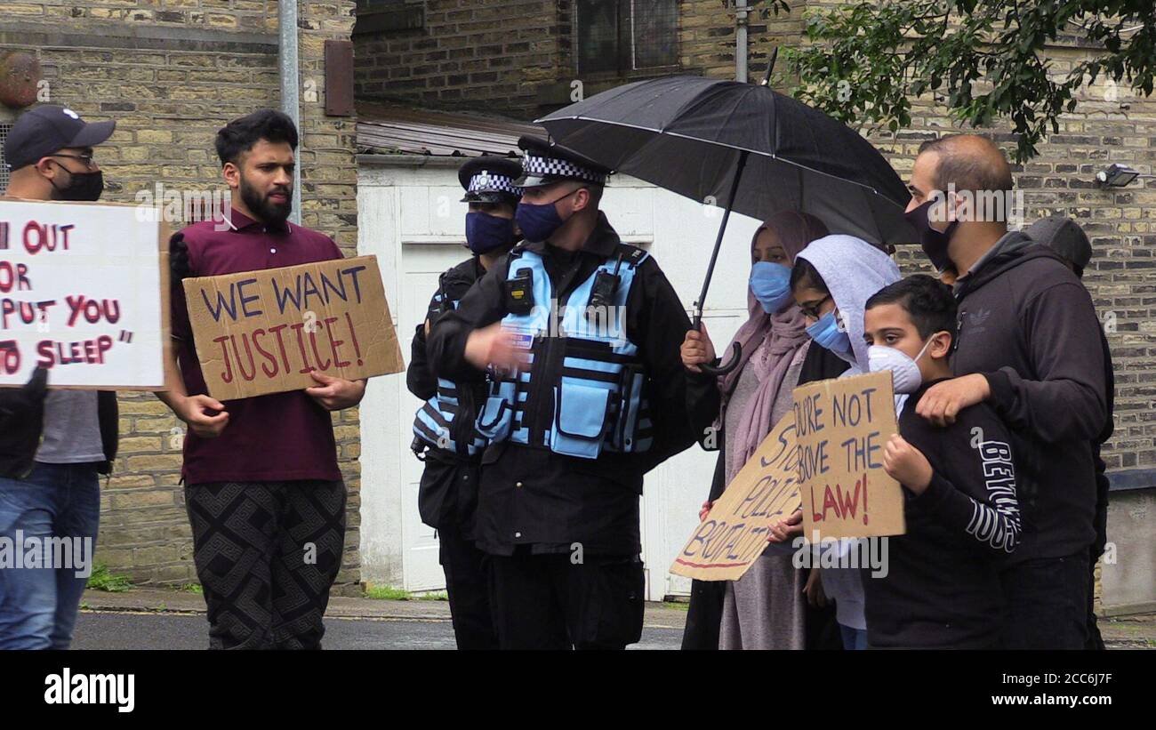 People with placards, gathered for a demonstration outside Halifax police station on Wednesday afternoon and police officers. A West Yorkshire officer has been suspended after a video was widely shared of Hassan Ahmed, 27, being arrested in Halifax on Sunday. Safyah is Hassan Ahmed's sister. Stock Photo