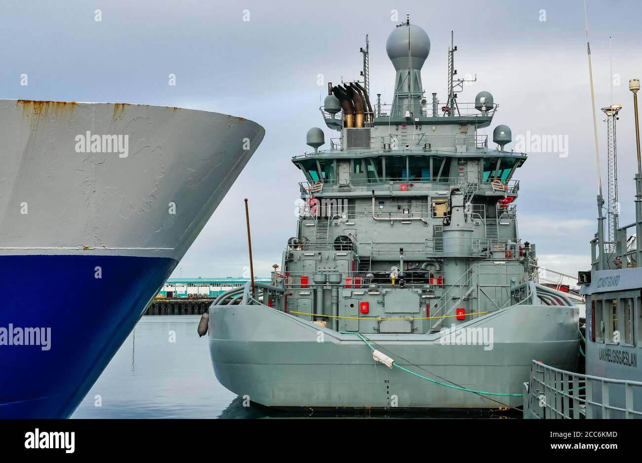 Naval vessel, prow of working ship and coastguard boat moored in harbour, Rekjavik, Iceland Stock Photo