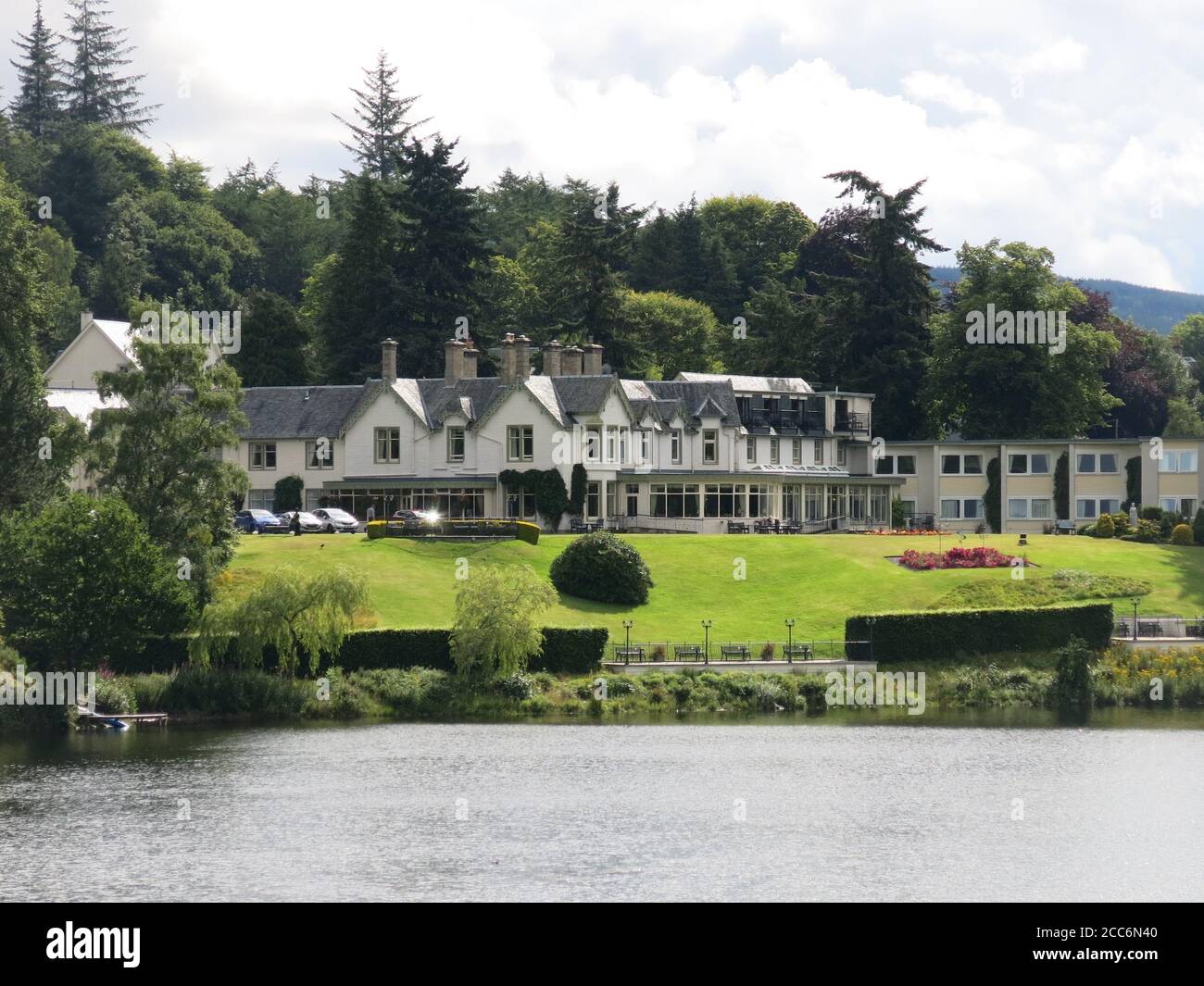 Hotel accommodation and Scottish hospitality: view of the Green Park Hotel in Pitlochry in its beautiful grounds on the banks of Loch Faskally Stock Photo