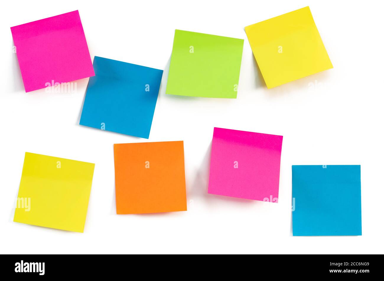 Colorful sticky notes isolated against a white wall. Close up. Space for ideas or messages. Stock Photo