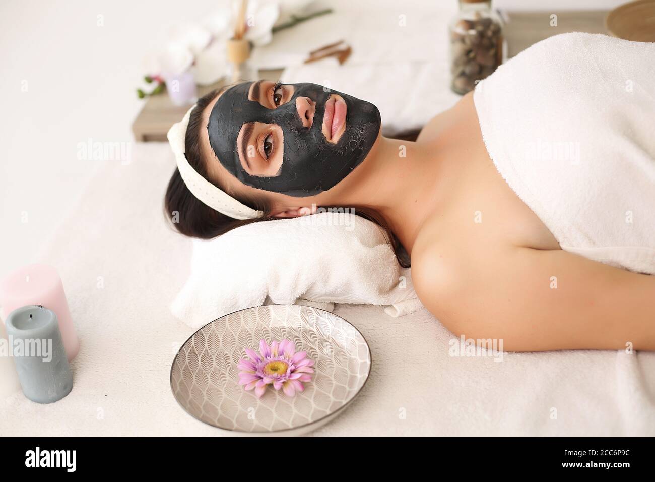 young beautiful woman with facial mask, spa treatment Stock Photo