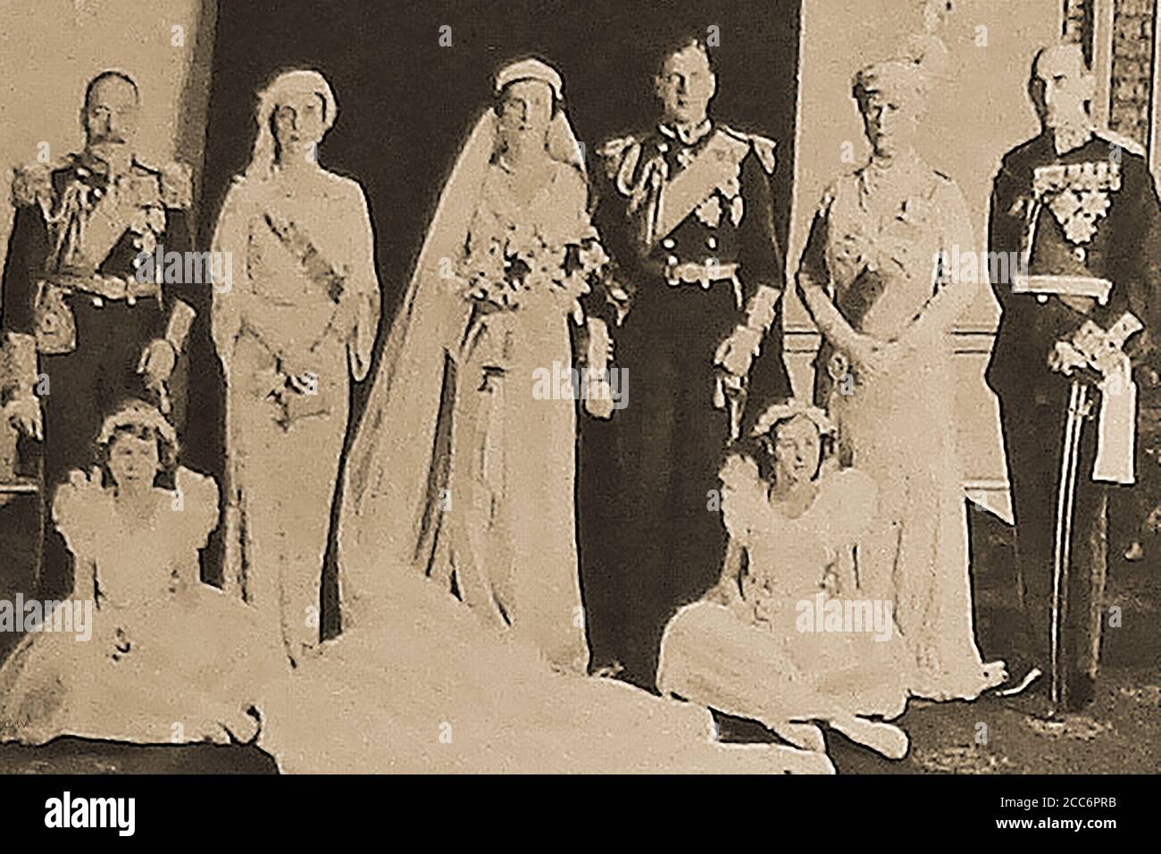 1934 - UK Royal Group portrait at the marriage of Prince George, Duke of Kent & Princess Marina of Greece & Denmark in Westminster Abbey, London.Their wedding was the first royal wedding ceremony to be broadcast by wireless and using microphones and loud speakers. Her dress was designed by designed by Edward Molyneux. Their 1st home was at 3 Belgrave Square.  The Princess was widowed in 1942, when her husband was killed in a plane crash on active service. Stock Photo