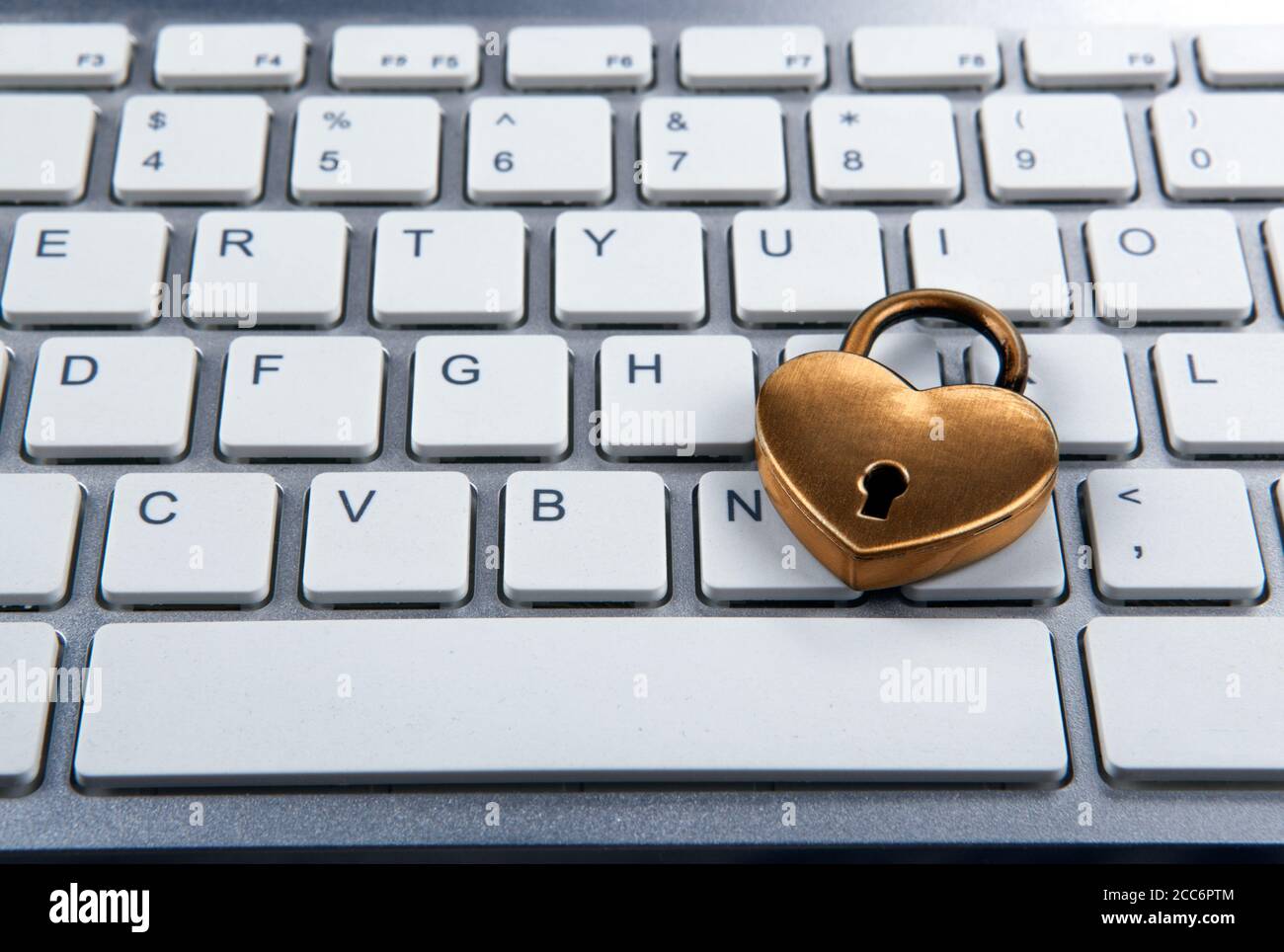 golden padlock on computer keyboard closeup Stock Photo