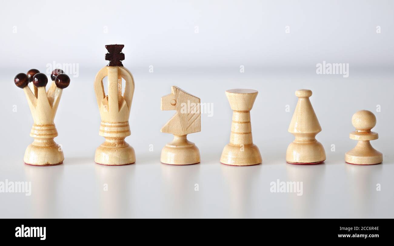 All six white chess pieces in a row on white background Stock Photo