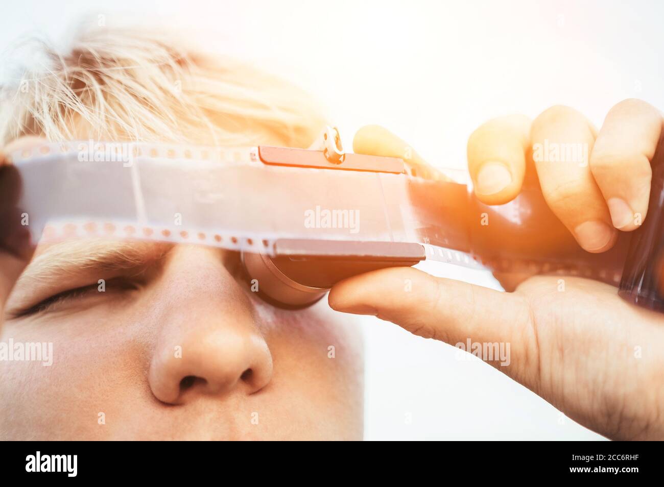 Male uses the Old vintage 35mm film Negative Viewer to see a frames