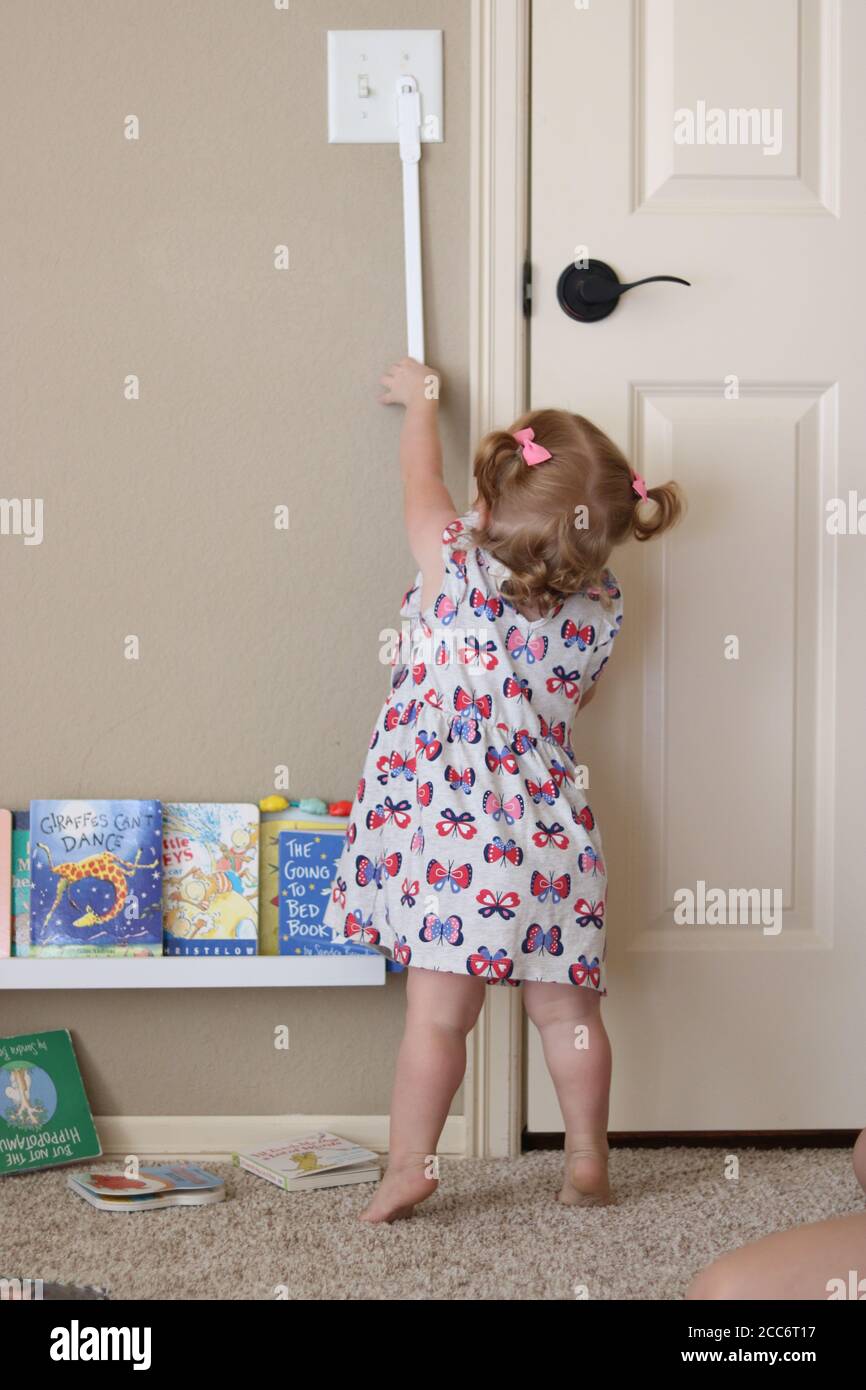Child turning on light by herself Stock Photo Alamy