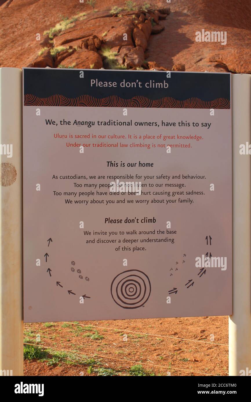 AUSTRALIA, NORTHERN TERRITORY, ULURU-KATA TJUTA NATIONAL PARK, AUGUST 09, 2016: Metal plate with the request that nobody should climb on the Uluru Stock Photo